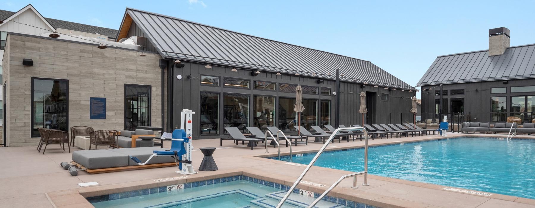 The Madison at Copperleaf's community swimming pool with ample lounge seating