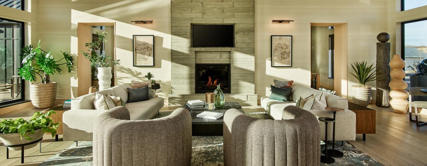 The Madison at Copperleaf's community clubhouse room with ample seating and a fireplace