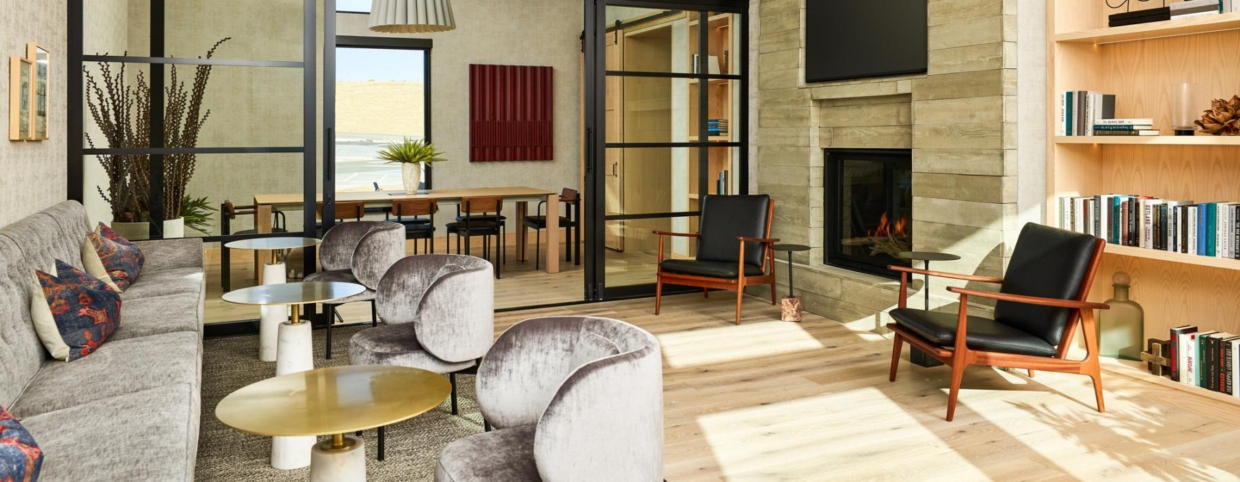 Community co-working space with a fireplace and access to a conference room at The Madison at Copperleaf